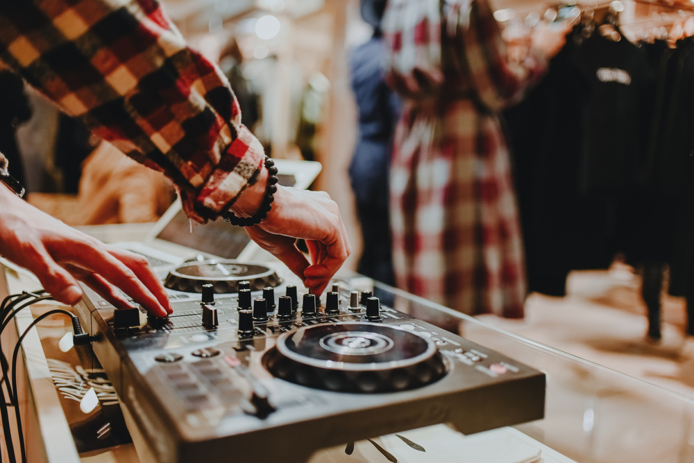 Dj mixes tracks at store opening event